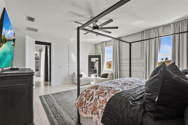 bedroom with light tile patterned floors, a textured ceiling, and ceiling fan