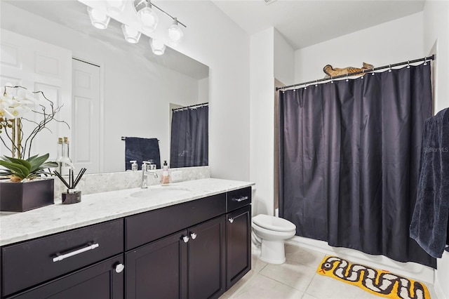 bathroom featuring tile patterned flooring, vanity, and toilet