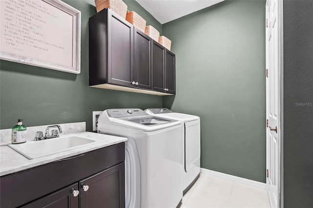 laundry room featuring cabinets, washer and dryer, sink, and light tile patterned floors