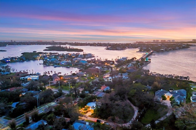 aerial view at dusk with a water view