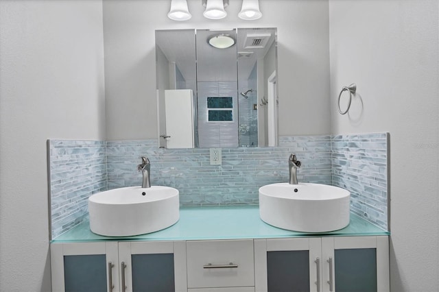 bathroom featuring tiled shower, tasteful backsplash, and vanity