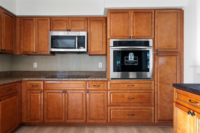 kitchen with light hardwood / wood-style floors and stainless steel appliances