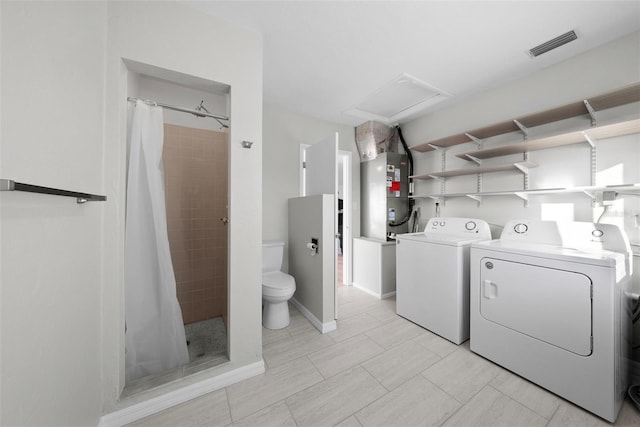 laundry area with washer and dryer and heating unit