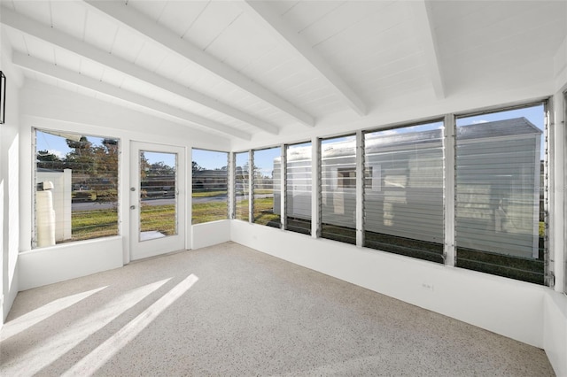 unfurnished sunroom featuring vaulted ceiling with beams