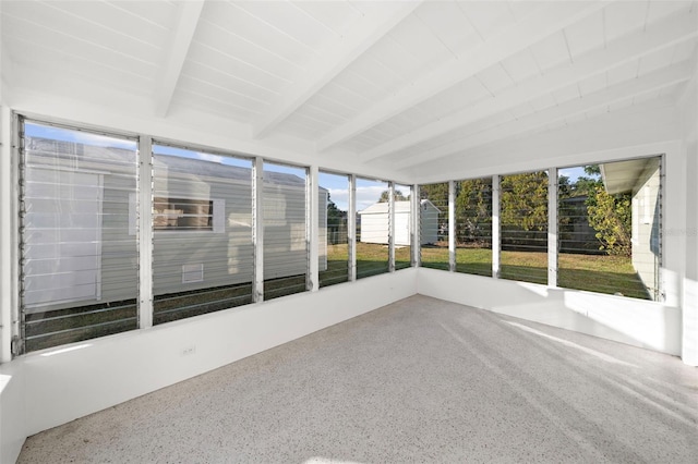 unfurnished sunroom with beam ceiling