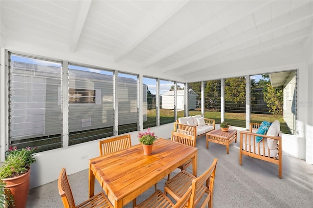 sunroom / solarium featuring beam ceiling