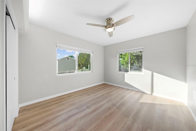 unfurnished room with ceiling fan and light hardwood / wood-style flooring