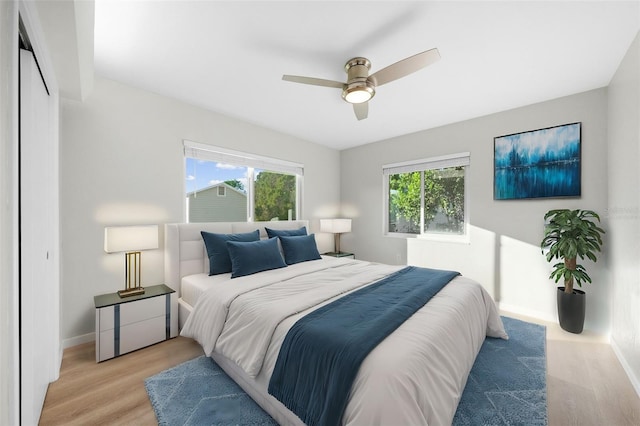 bedroom featuring a closet, ceiling fan, and light hardwood / wood-style flooring