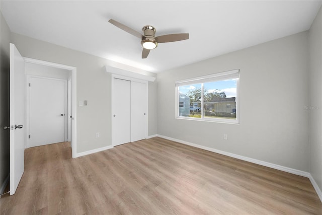 unfurnished bedroom featuring ceiling fan, light hardwood / wood-style flooring, and a closet