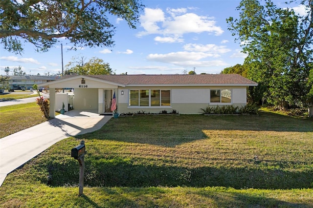 ranch-style house featuring a carport, a front yard, and driveway