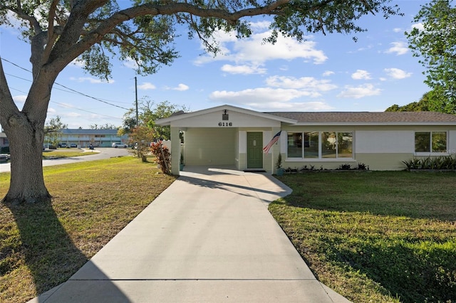 ranch-style house featuring a front yard and a carport