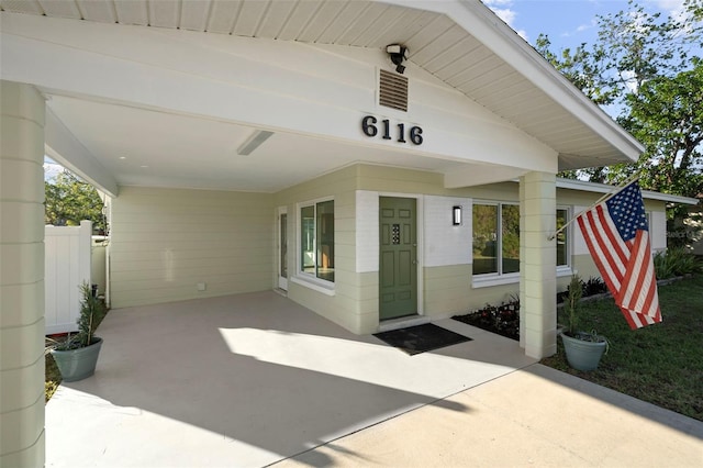 property entrance featuring a carport