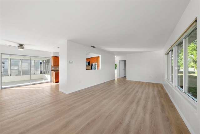 unfurnished living room with ceiling fan and light hardwood / wood-style floors