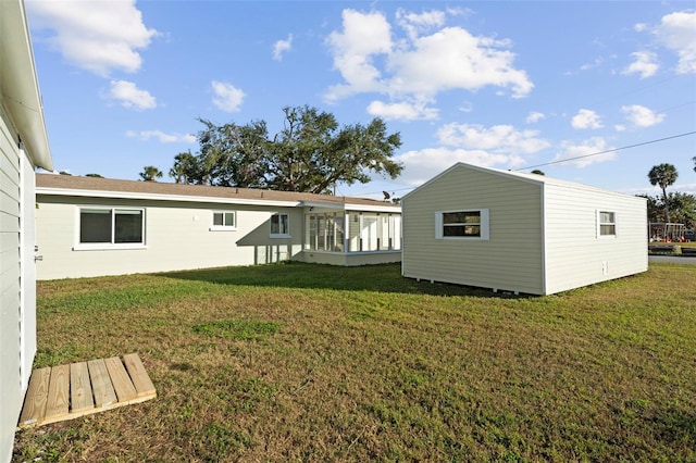 rear view of house featuring a lawn