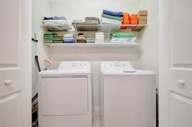 clothes washing area with separate washer and dryer