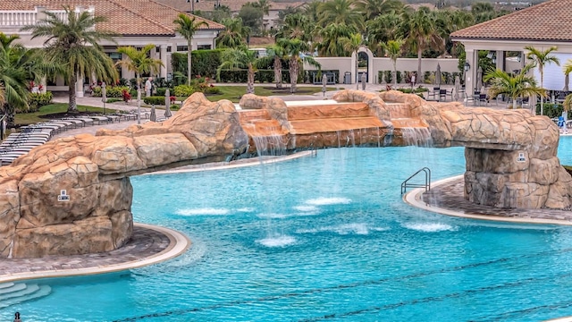 view of pool with pool water feature