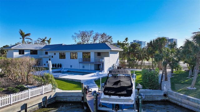 back of house featuring a balcony, a yard, a swimming pool, and a patio area