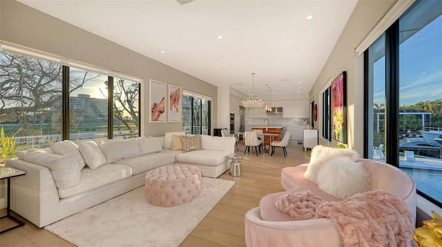 living room featuring a chandelier and light hardwood / wood-style floors