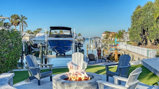 view of patio / terrace with a water view, a boat dock, and an outdoor fire pit