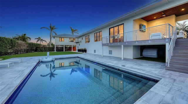 view of pool with fence, stairs, a yard, a fenced in pool, and a patio area