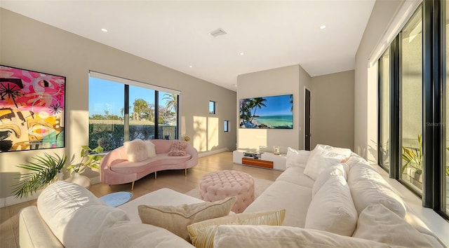 living room featuring visible vents and recessed lighting