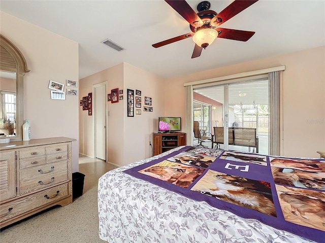 bedroom featuring access to outside, ceiling fan, and multiple windows