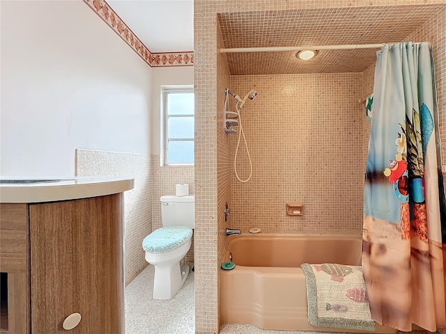 bathroom featuring tile walls, toilet, and shower / tub combo with curtain