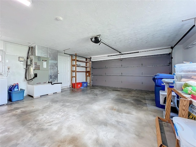 garage with washer / dryer and a garage door opener