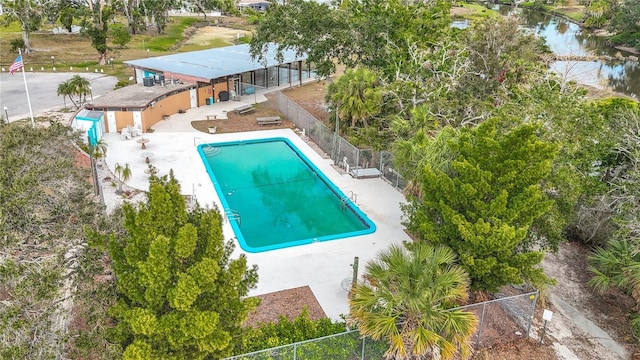 view of swimming pool featuring a water view and a patio