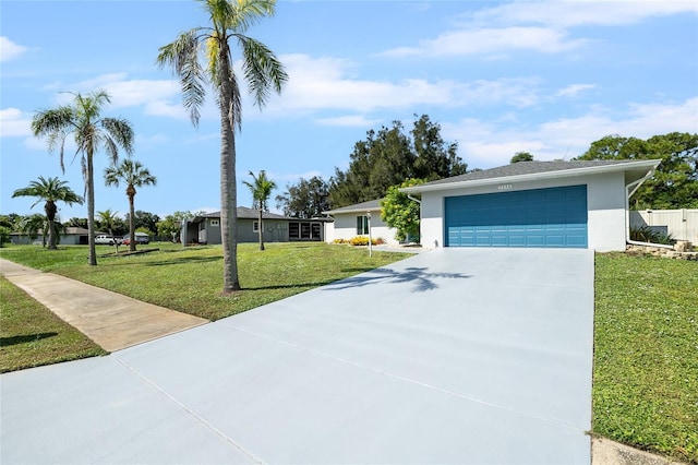 view of front of home with a front yard and a garage