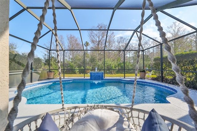 view of swimming pool featuring a lanai