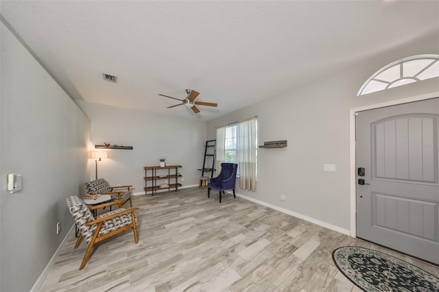 entrance foyer with ceiling fan and light hardwood / wood-style flooring