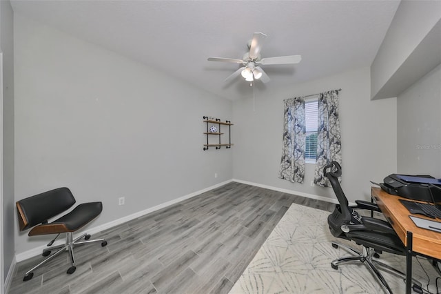 office featuring light wood-type flooring and ceiling fan