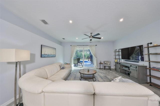 living room with ceiling fan and hardwood / wood-style flooring