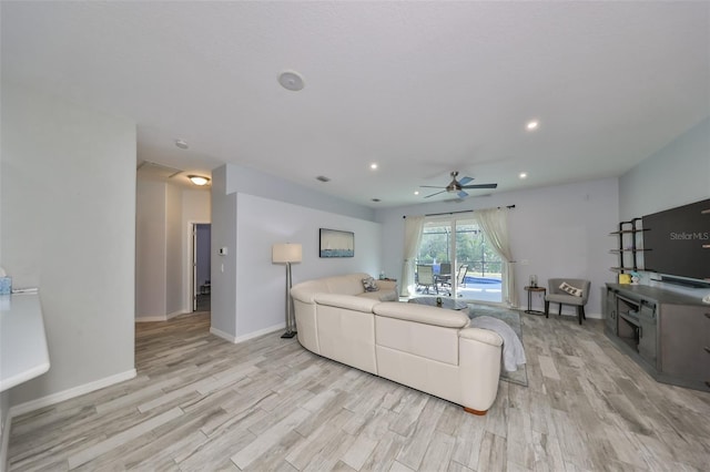 living room with ceiling fan and light hardwood / wood-style floors