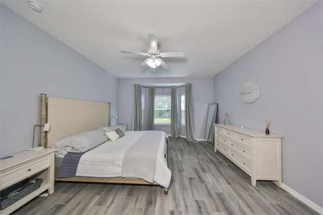 bedroom with ceiling fan and light wood-type flooring