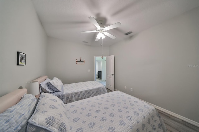 bedroom with ceiling fan and hardwood / wood-style flooring