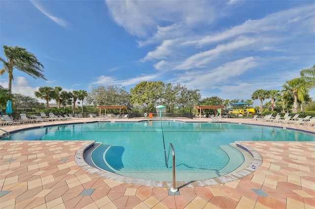 view of swimming pool with a patio area and a pergola