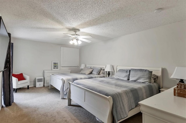 carpeted bedroom with a textured ceiling and ceiling fan