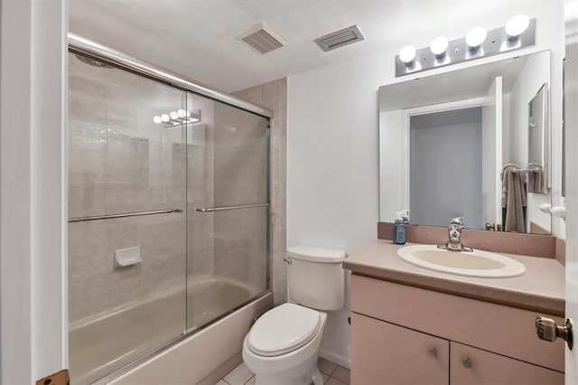 full bathroom with toilet, vanity, tile patterned floors, and enclosed tub / shower combo