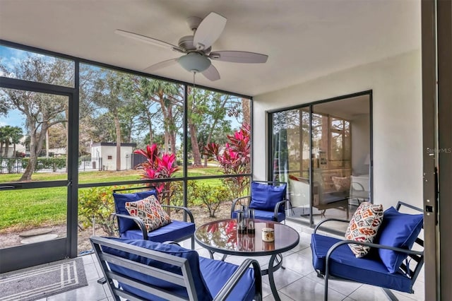 sunroom / solarium featuring ceiling fan