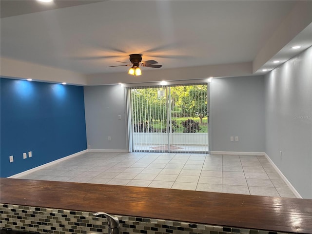 empty room featuring ceiling fan and light tile patterned flooring