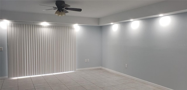 tiled spare room featuring ceiling fan