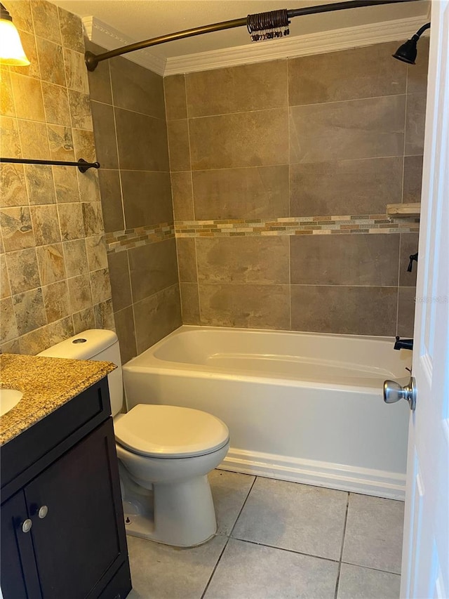 full bathroom with tile patterned floors, tiled shower / bath, toilet, vanity, and ornamental molding