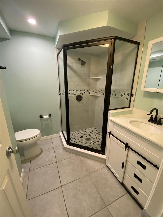 bathroom featuring vanity, toilet, tile patterned floors, and a shower with door