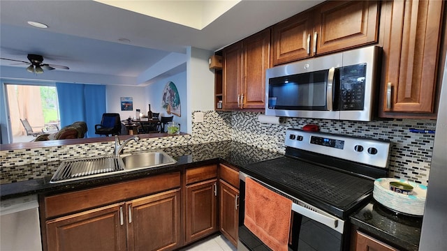 kitchen featuring ceiling fan, appliances with stainless steel finishes, sink, backsplash, and light tile patterned floors