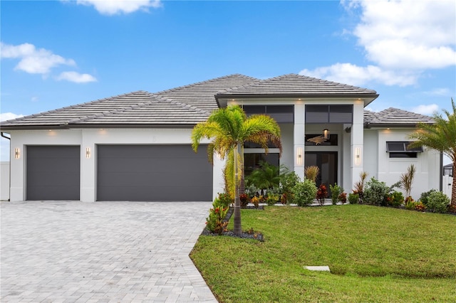 view of front facade with a garage and a front lawn