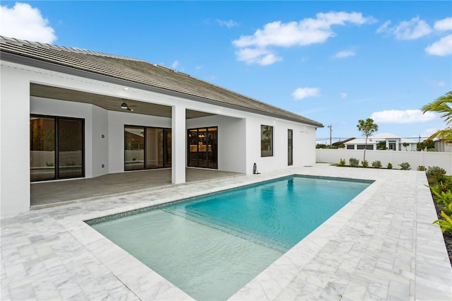 view of swimming pool featuring a patio area and ceiling fan