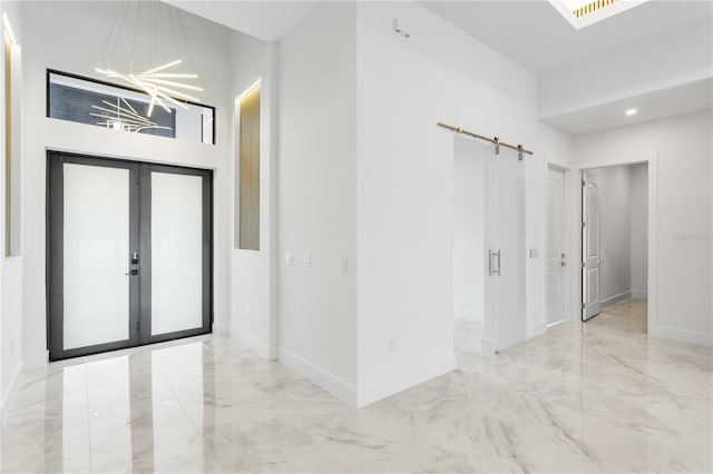 entrance foyer featuring french doors and an inviting chandelier