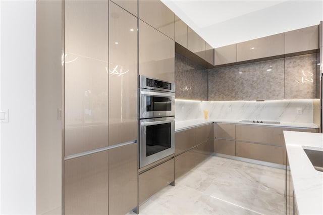 kitchen featuring gray cabinets, light stone countertops, double oven, and black electric cooktop